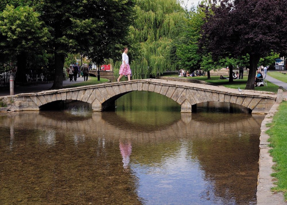Low stone footbridges over the River Windrush at Bourton-on-the-Water