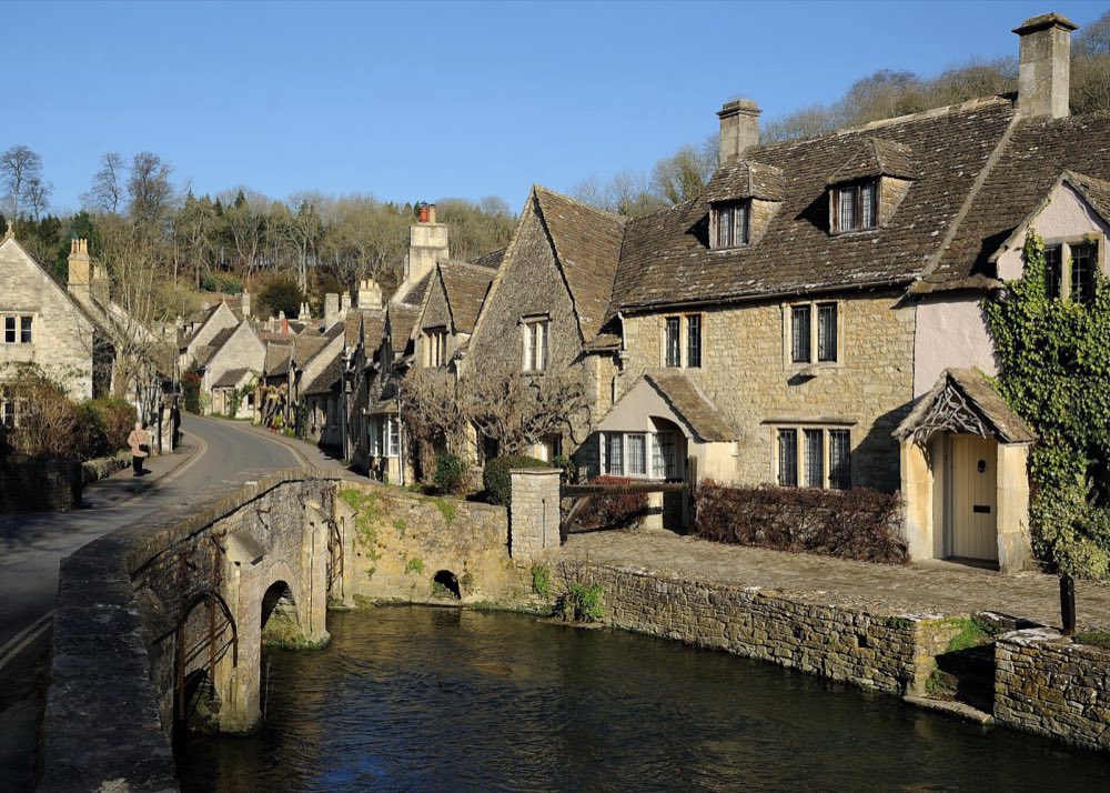 The main street of Castle Combe, stone cottages running down to a brook