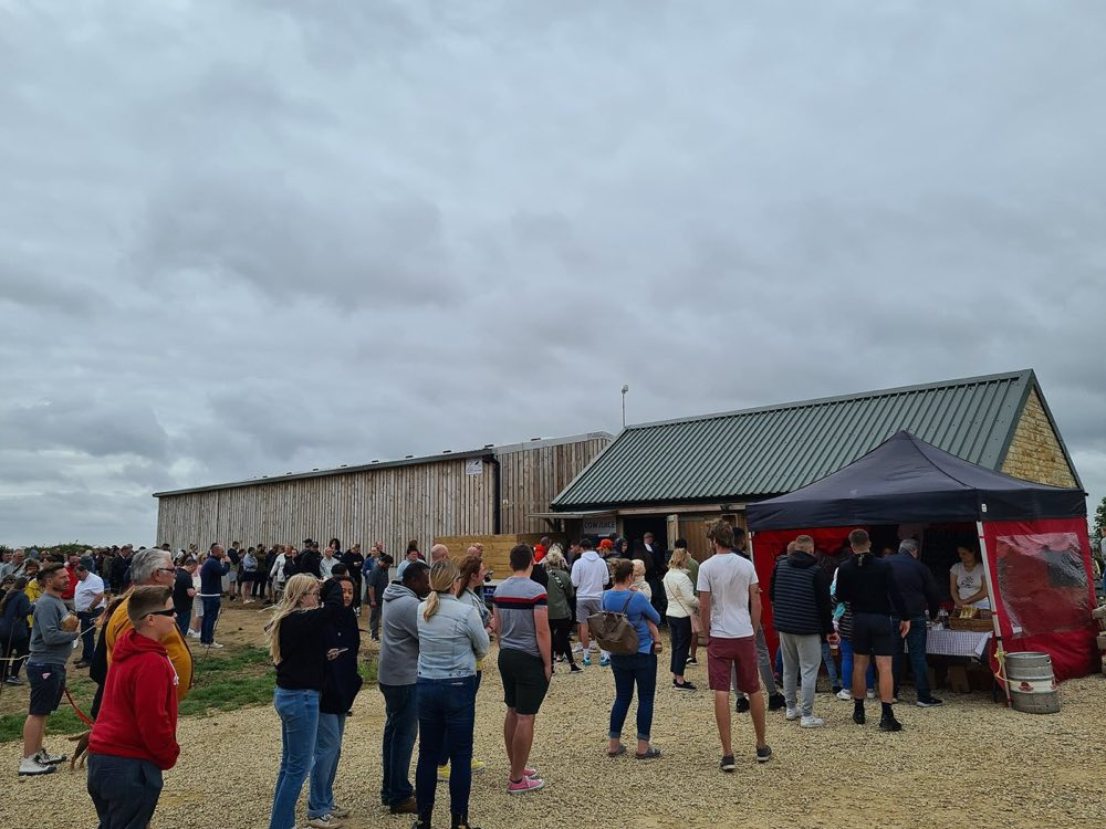 A long queue of visitors waiting outside Diddly Squat Farm Shop