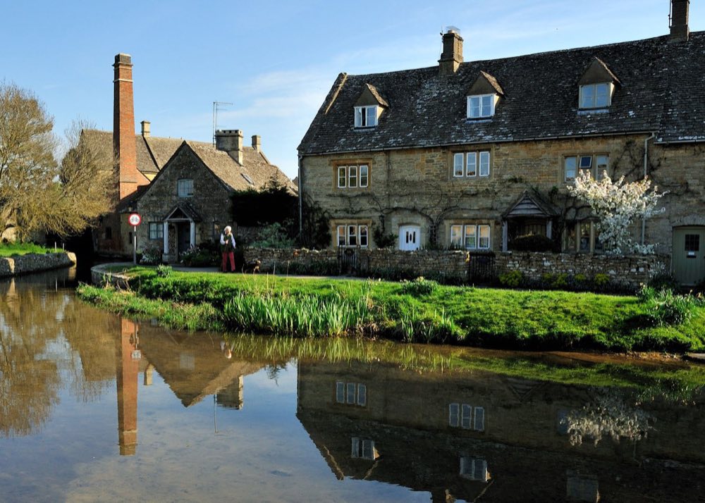 The mill and millpond at Lower Slaughter, with the River Eye running past stone cottages